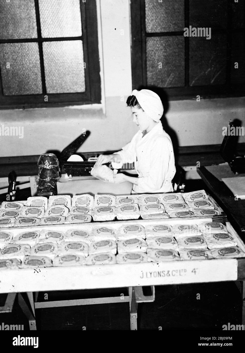 In thousands of British homes this Christmas, rich plum puddings, which are earning precious dollars, will be on the menu. At Cadby Hall, Lyons' London headquarters, puddings, fruitcake and tea are been prepared for the dispatch under a scheme whereby American and Canadian friends cable instructions (and dollars) for Christmas packages to be sent to homes in Britain. Special allocations of materials for this unusual export fare, which never leaves the country have been made by the Ministry of Food. - 10 December 1947 Stock Photo