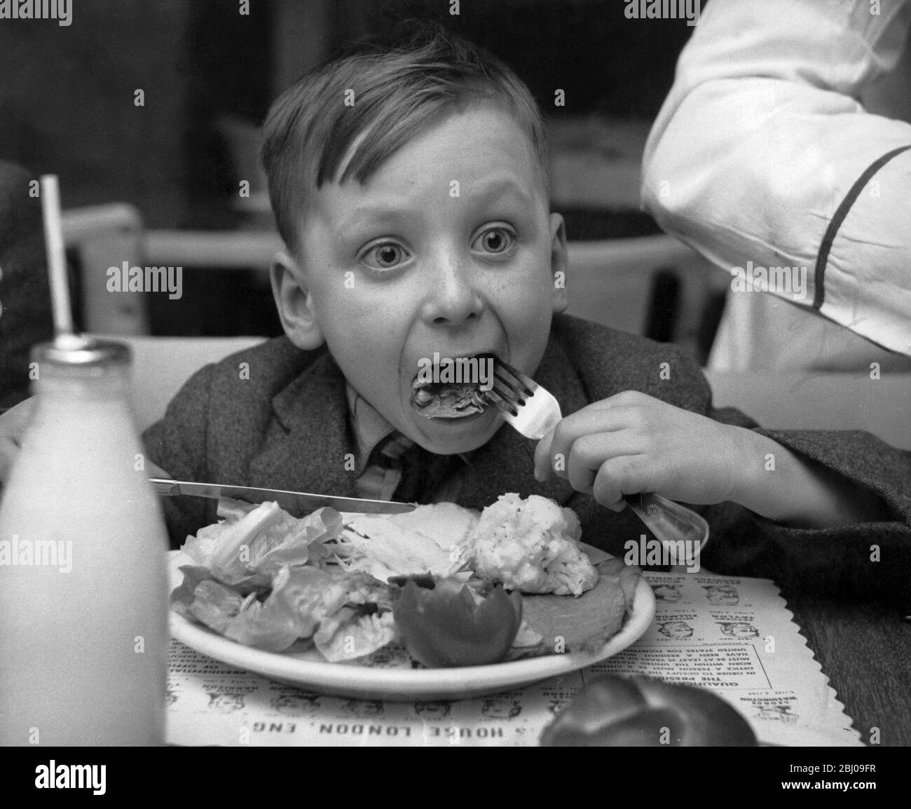 Philip Davies, age 6 during a Christmas party lunch at Douglas House, Lancaster Gate, London held by US Servicemen for boys of broken marriages and orphans. - 13th December 1960 Stock Photo