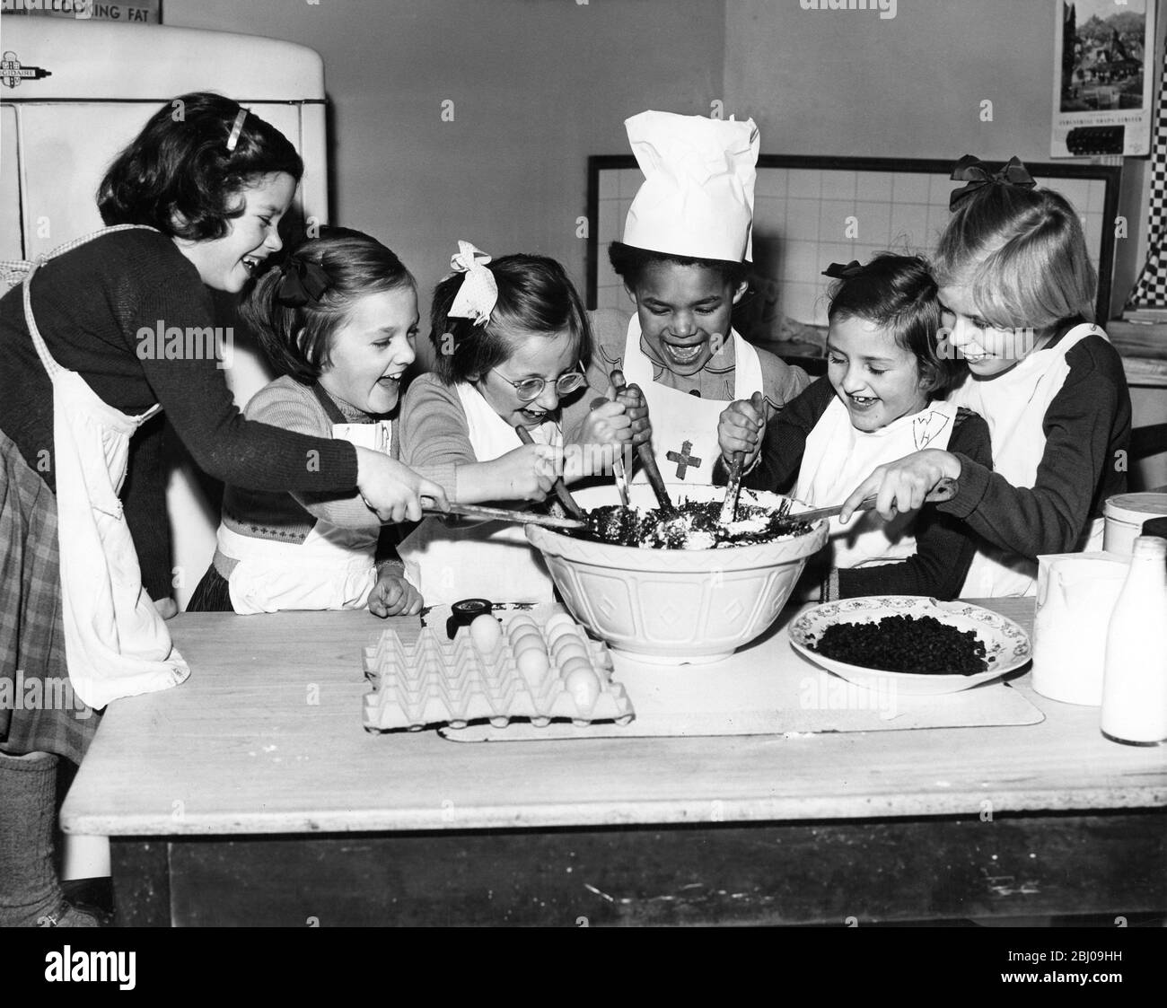 Young girls make Christmas Pudding at Dr Barnardo's Home at Beckenham, Kent, England - 3 December 1959 Stock Photo