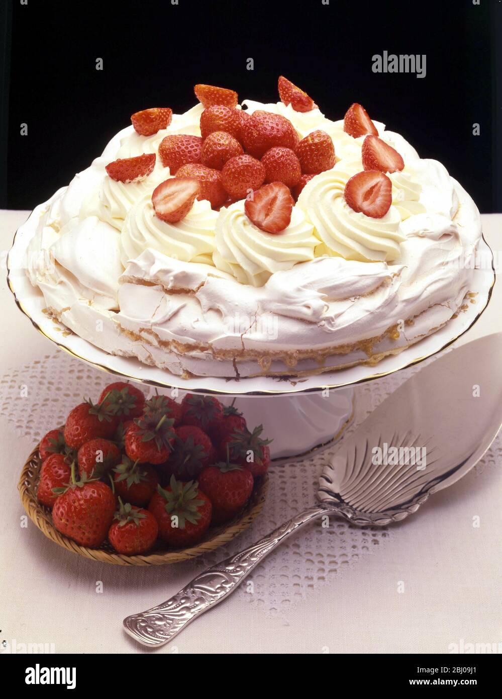 Strawberry Pavlova - The meringue-based dessert, Pavlova, is named after the Russian ballerina Anna Pavlova. The dessert is believed to have been created in honour of the dancer either during or after one of her tours to Australia and New Zealand in the 1920s. Stock Photo