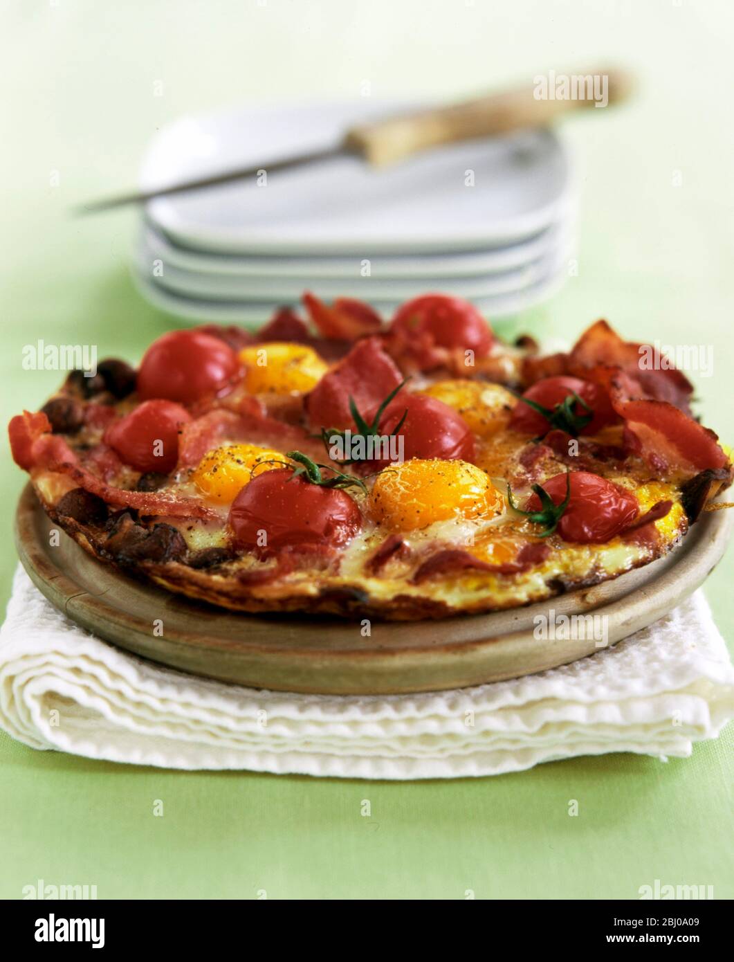 A brunch dish of an open omelette with pizza style toppings. Stock Photo