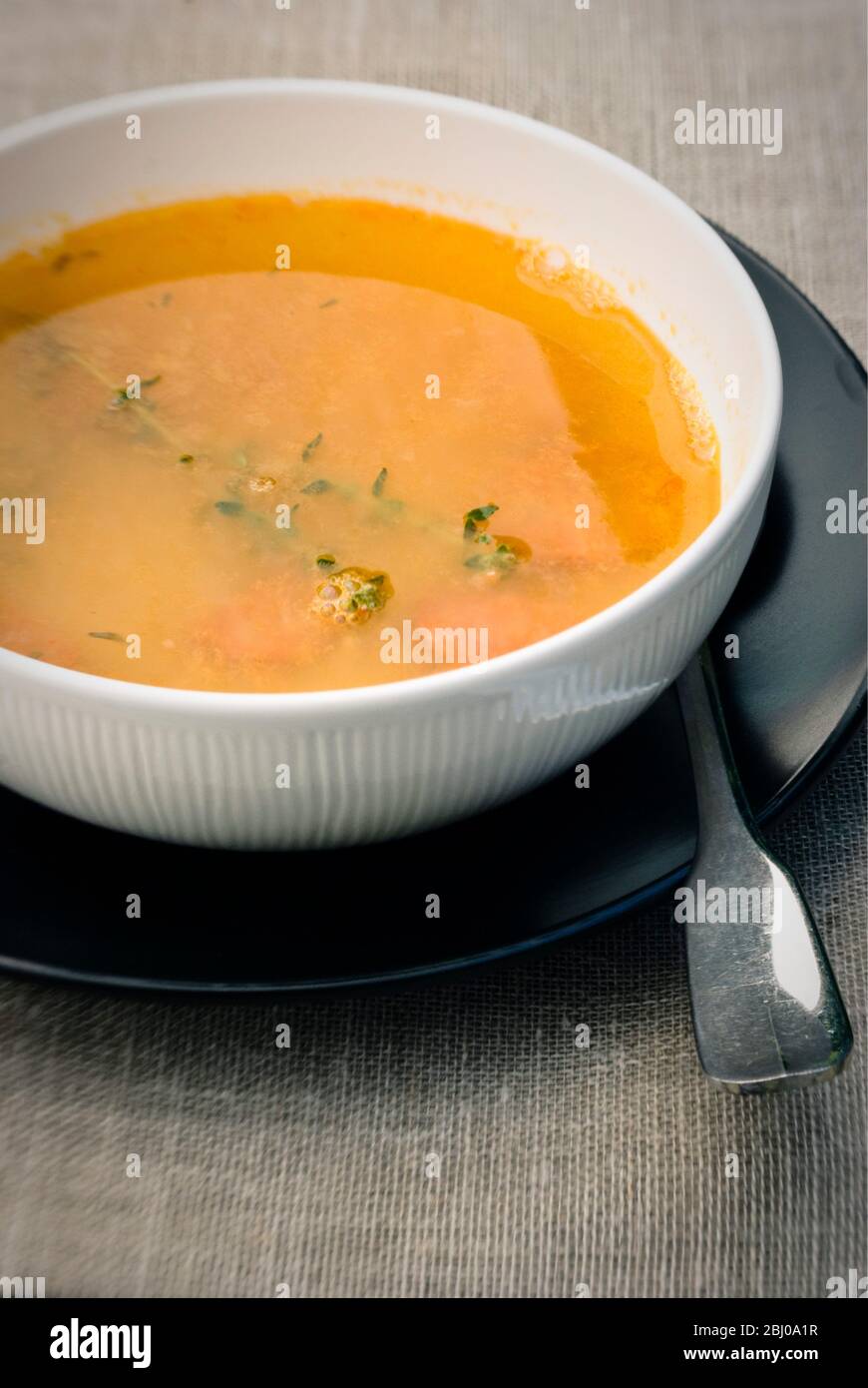 soup of yellow split peas with carrots and fresh thyme Stock Photo