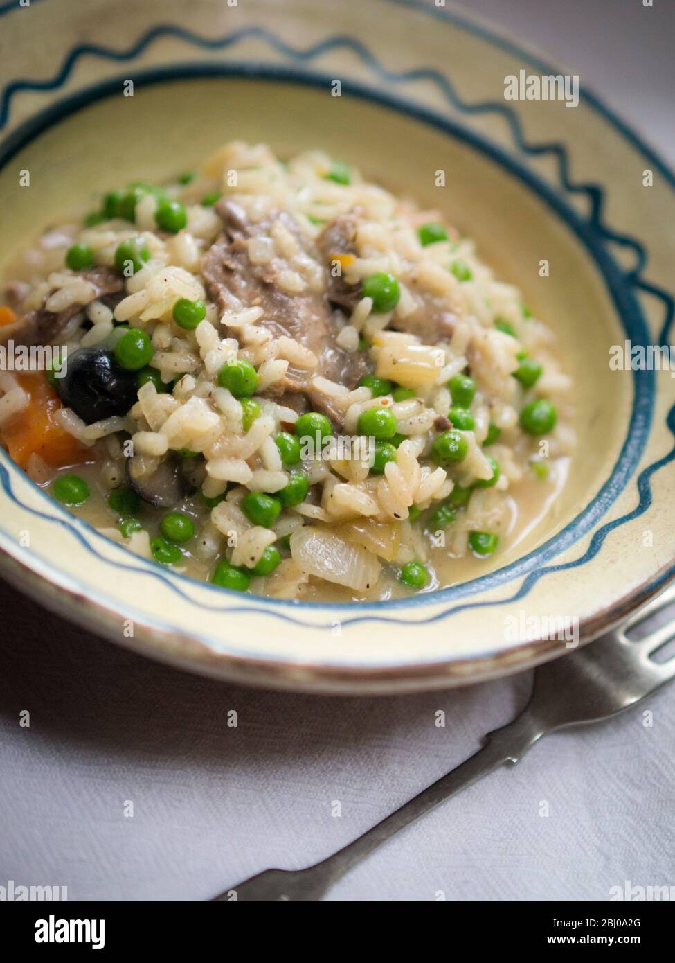 Risotto made from leftovers from wild duck braised with olives. Stock Photo
