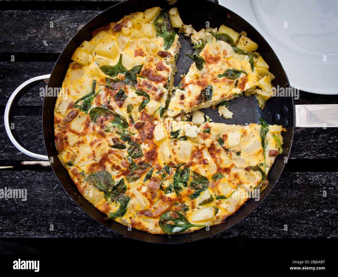 Prawn and spinach frittata with aluminium foil being wrapped fro a picnic Stock Photo
