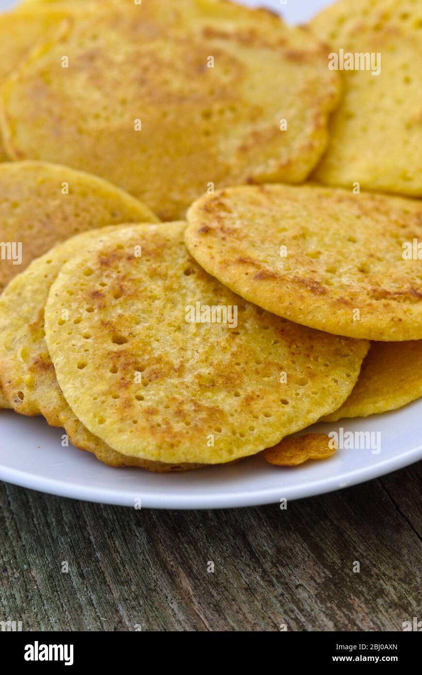 Little pancakes made of Indian chick pea flour (chana dal), gluten free and very nutritious. - Stock Photo