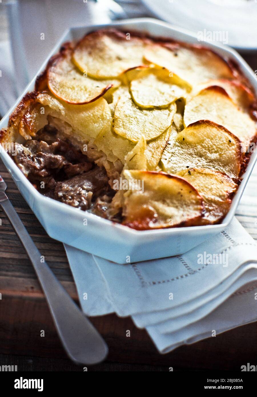Lancashire hotpot: Classic English dish of beef and onions with layered potato slice topping - Stock Photo