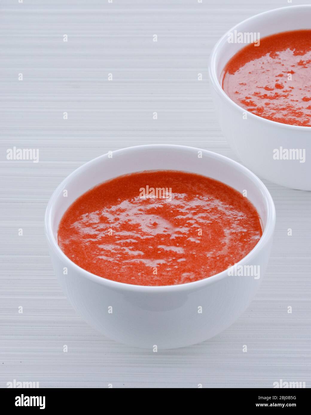Chilled gazpacho soup in white bowls - Stock Photo