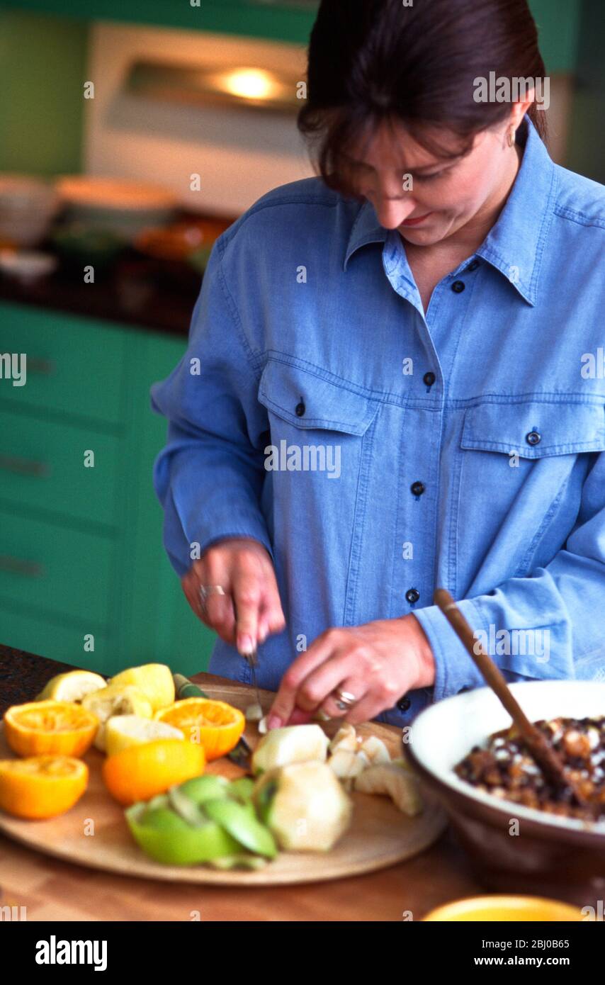 Prepaing citurs fruits for Christmas mincemeat - Stock Photo