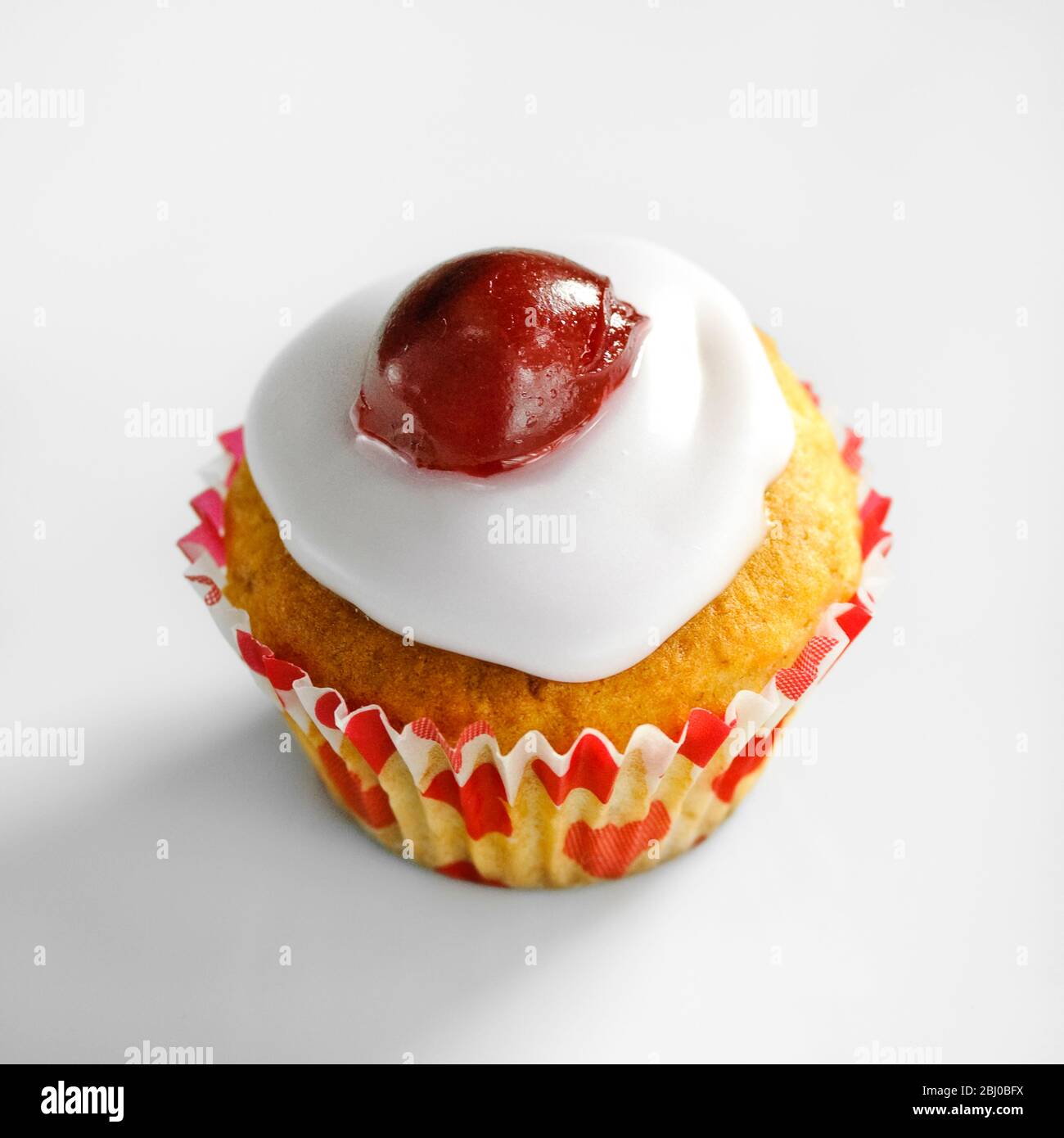 Cherry topped mini muffins on white background - Stock Photo