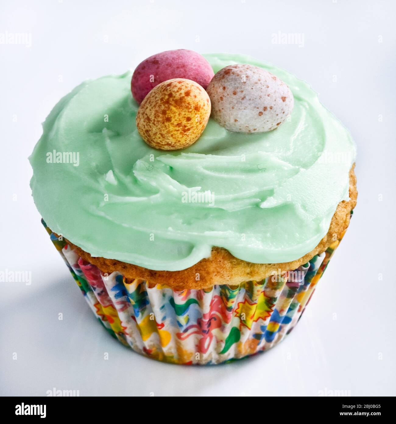 Iced Easter cupcake with chocolate mini eggs - Stock Photo
