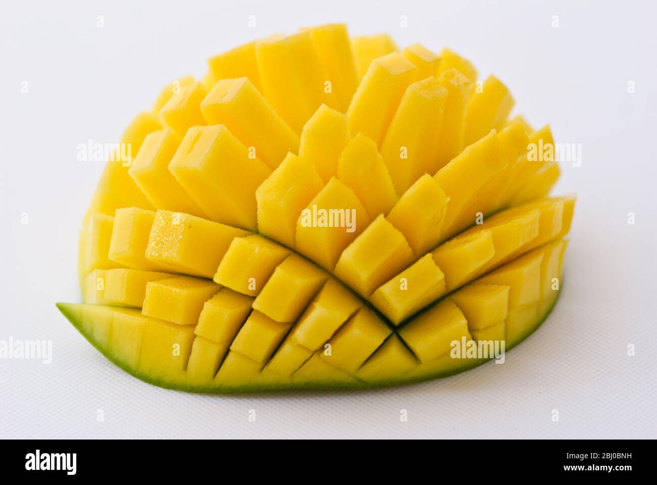 Fresh mango showing technique for cutting into cubes - Stock Photo