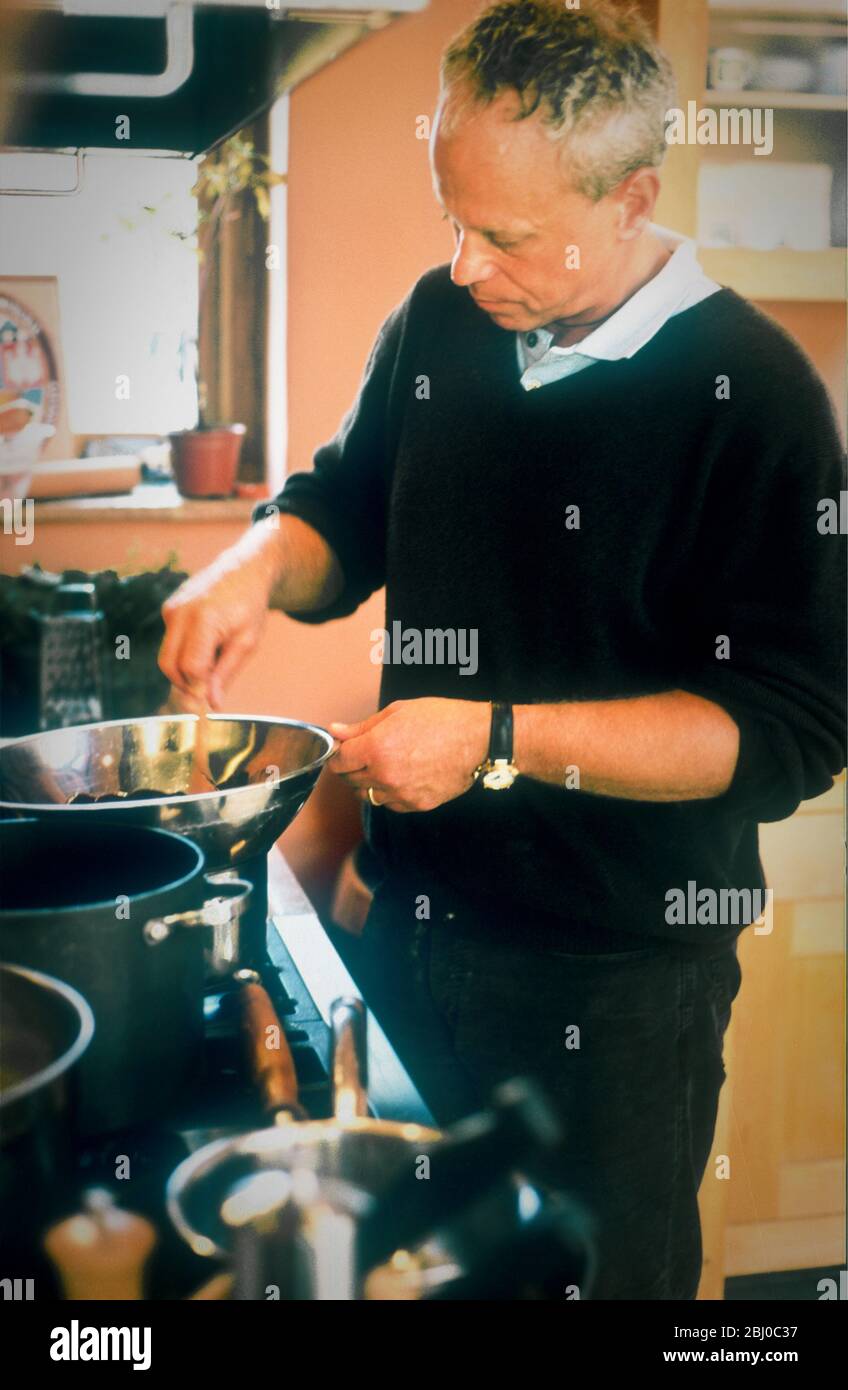 Chef John Burton-Race, cooking in his kitchen - Stock Photo
