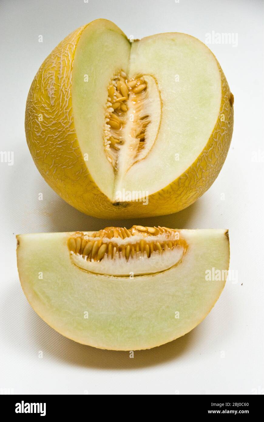Gallia melon with section cutout on white background - Stock Photo