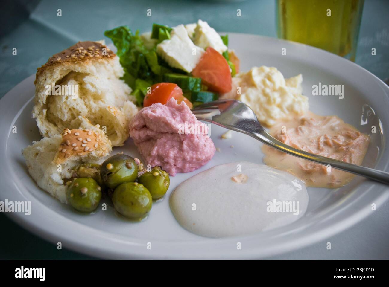 Starter dishes of meze in Greek Cypriot seafood restaurant on waterfront in Larnaca, southern Cyprus - Stock Photo