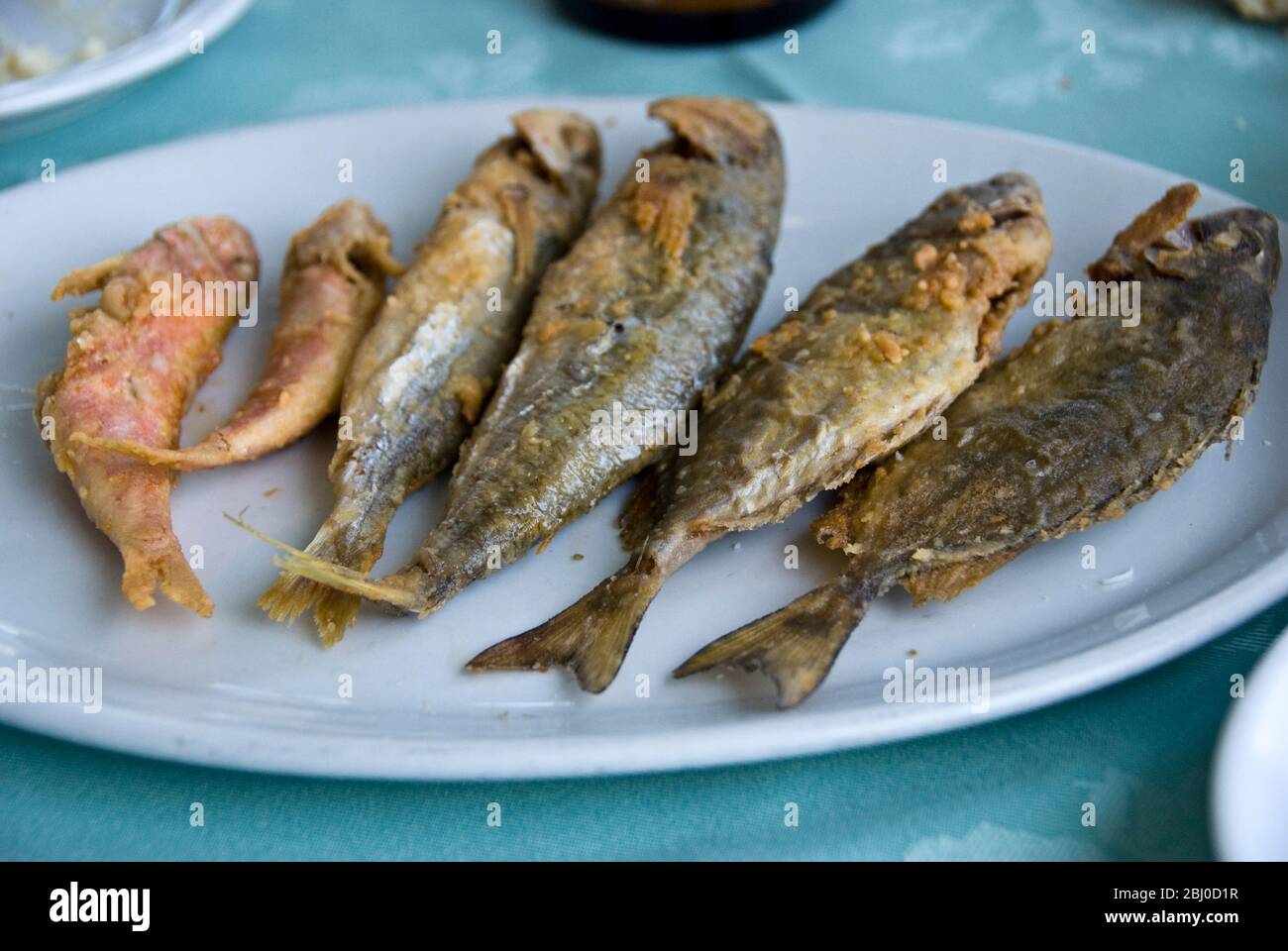 A selection of small fish deep fried in a thin light batter in a Greek Cypriot seafood restaurant in Larnaca, Southen Tyrkey - Stock Photo