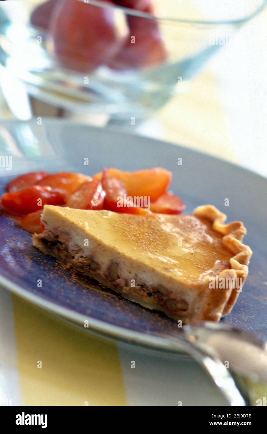 Walnut tart with poached plums - Stock Photo