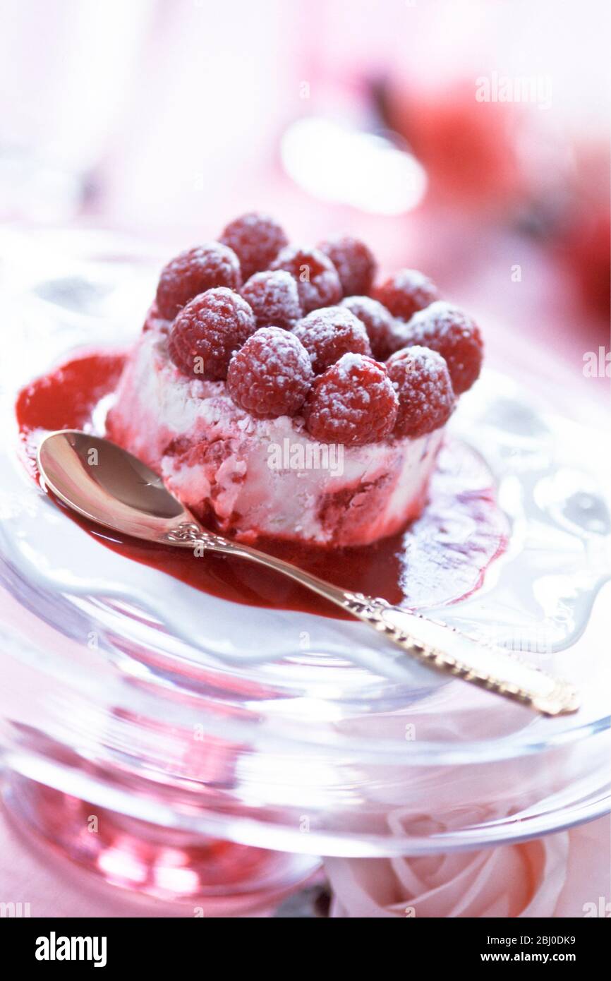 Raspberry icecream topped with fresh raspberries as special party dessert. - Stock Photo