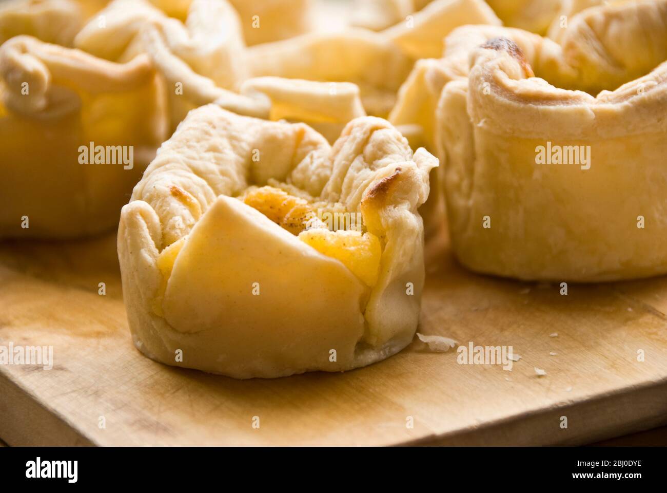 Home made portuguese style custard tarts with confectioners' custard and puff pastry - Stock Photo