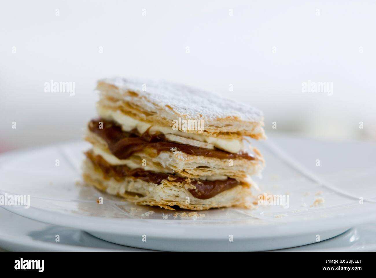 Layered mille feuilles pastry with whipped cream and dulce de leche. - Stock Photo