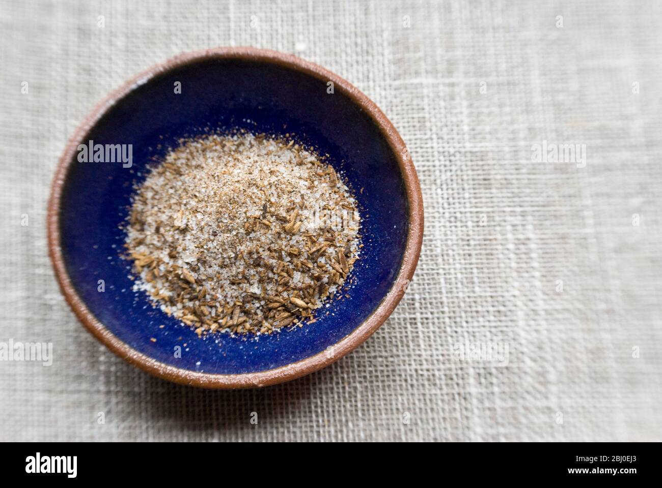 A mixture of sea salt and toasted, crushed cumin seeds, a popular seasoning for Morrocan food. - Stock Photo