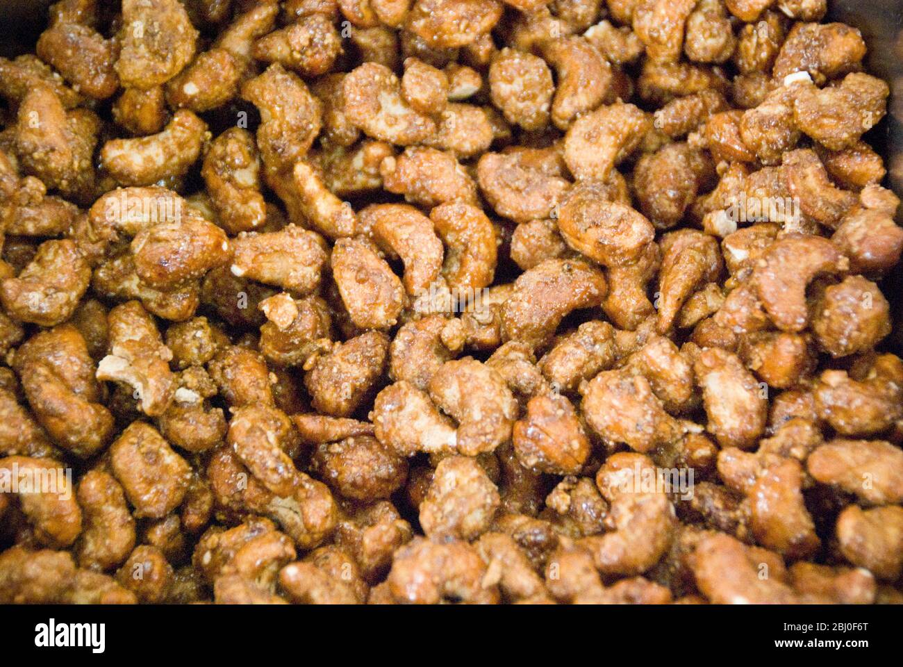 Caramelised cashew nuts on a stall in the covered market in Limassol, Cyprus - Stock Photo