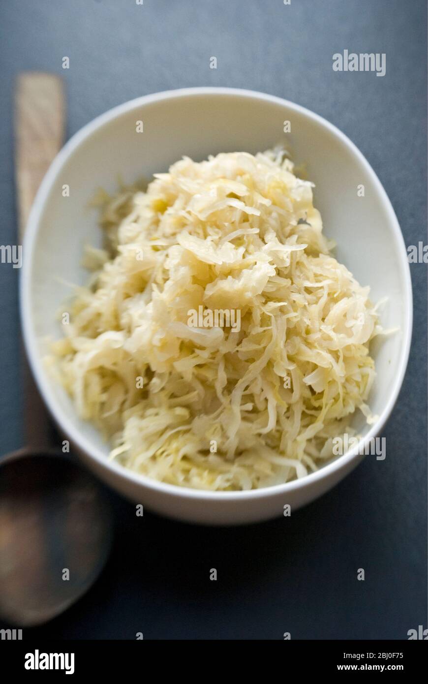 Small white dish of German sauerkraut. - Stock Photo