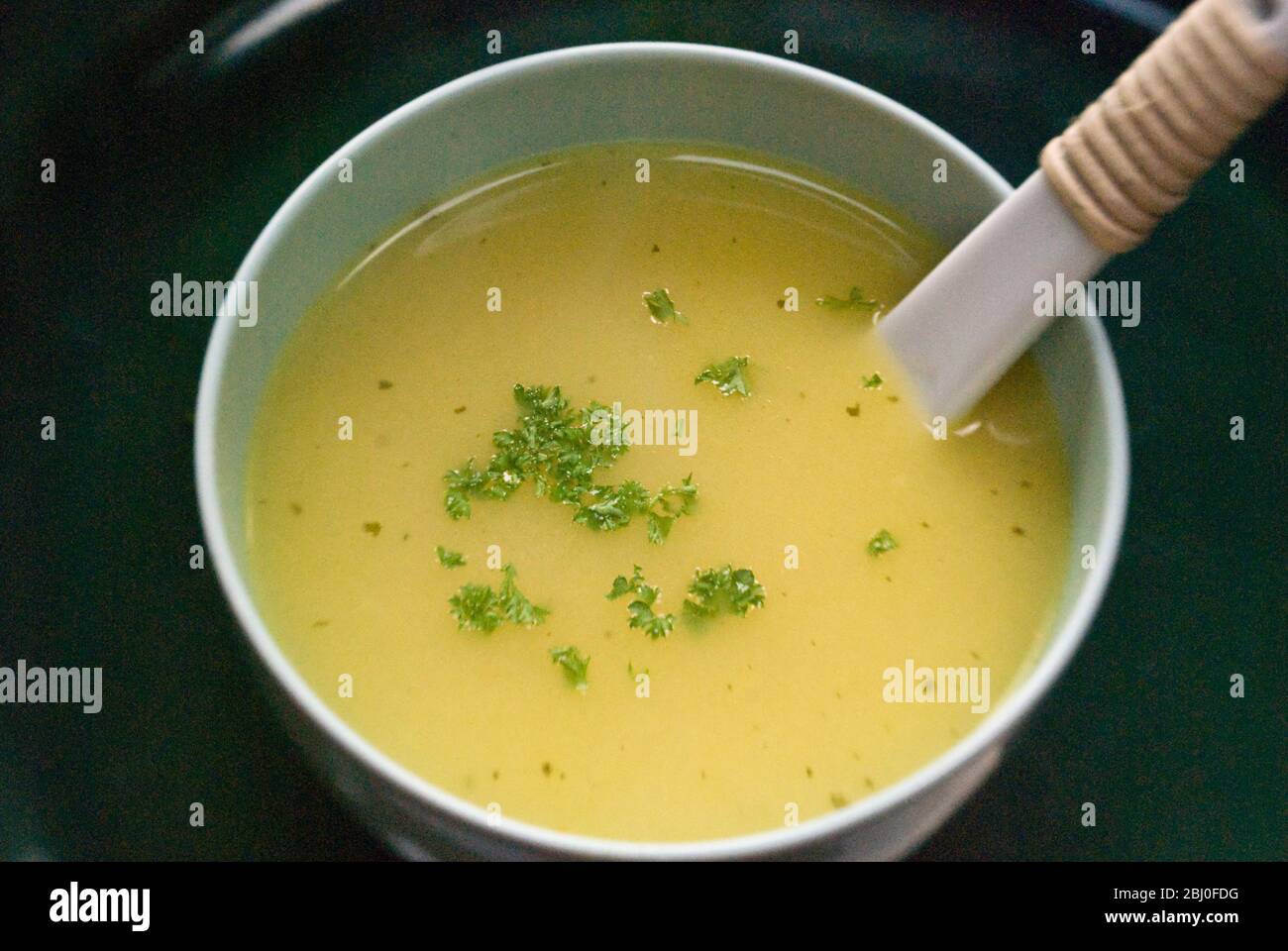 Chicken soup with chopped parsley Stock Photo Alamy