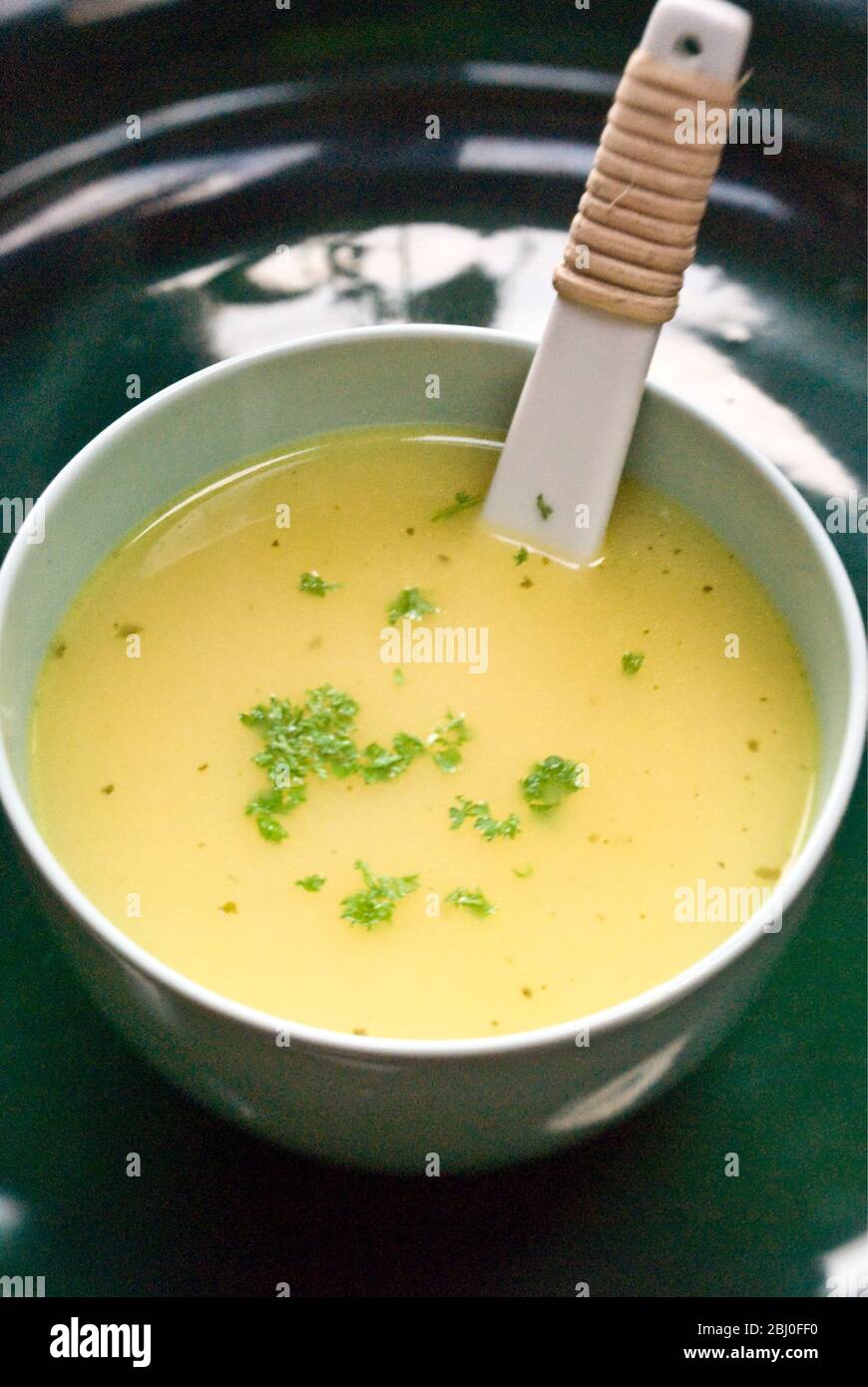 Chicken soup with chopped parsley Stock Photo Alamy