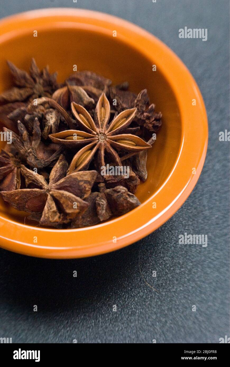 Dried Star anise fruits in small bowl. Also known as star aniseed