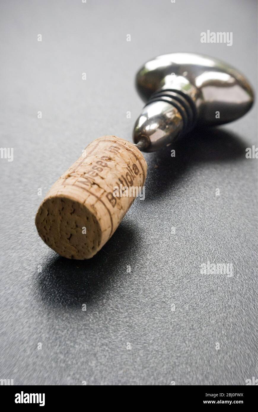 Silver plated corkscrew which doubles as a stopper, with cork - Stock Photo