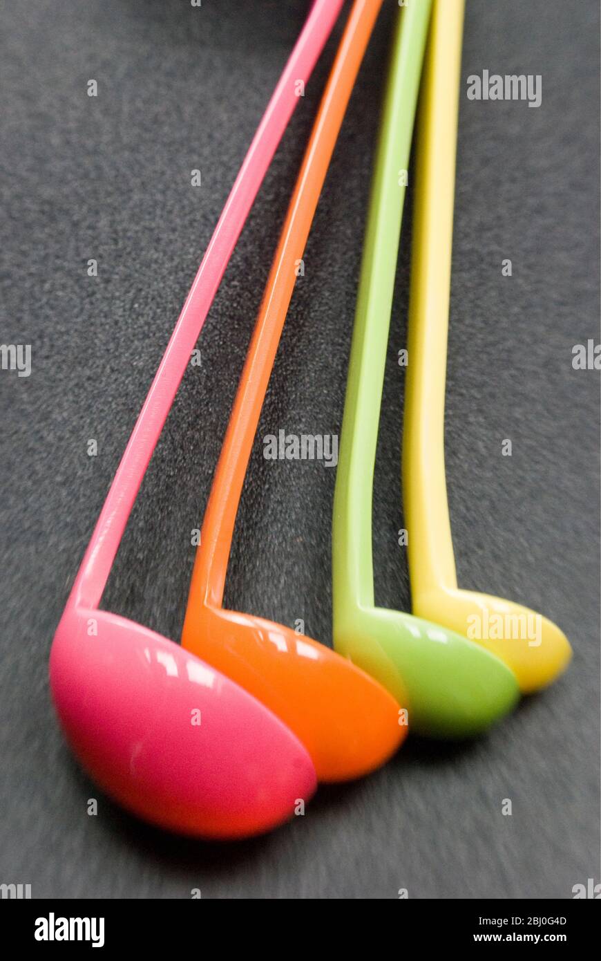 Set of brightly coloured melamine plastic measuring spoons - Stock Photo