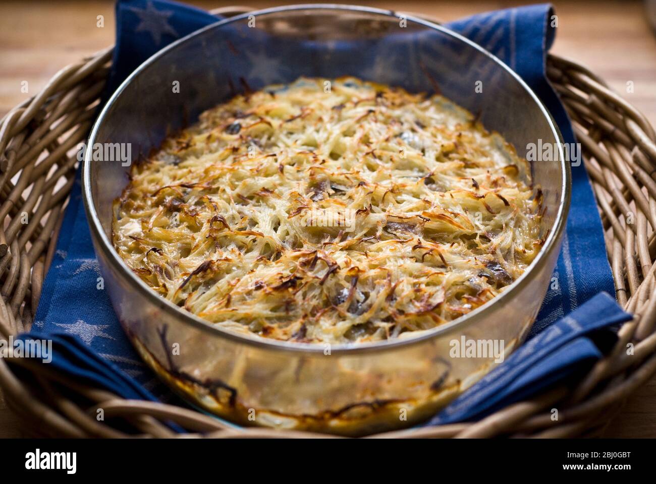 Jansson's Temptation', (Janssons Frestelse) a classic Swedish dish of potato, onion and Swedish 'anchovies' - in fact salted sprats. - Stock Photo