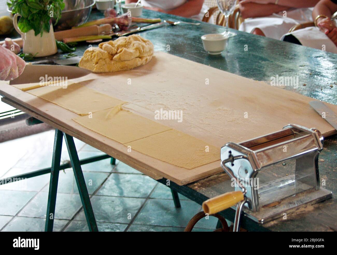 Pasta making being demonstrated at Italian cookery course in front of audience - Stock Photo