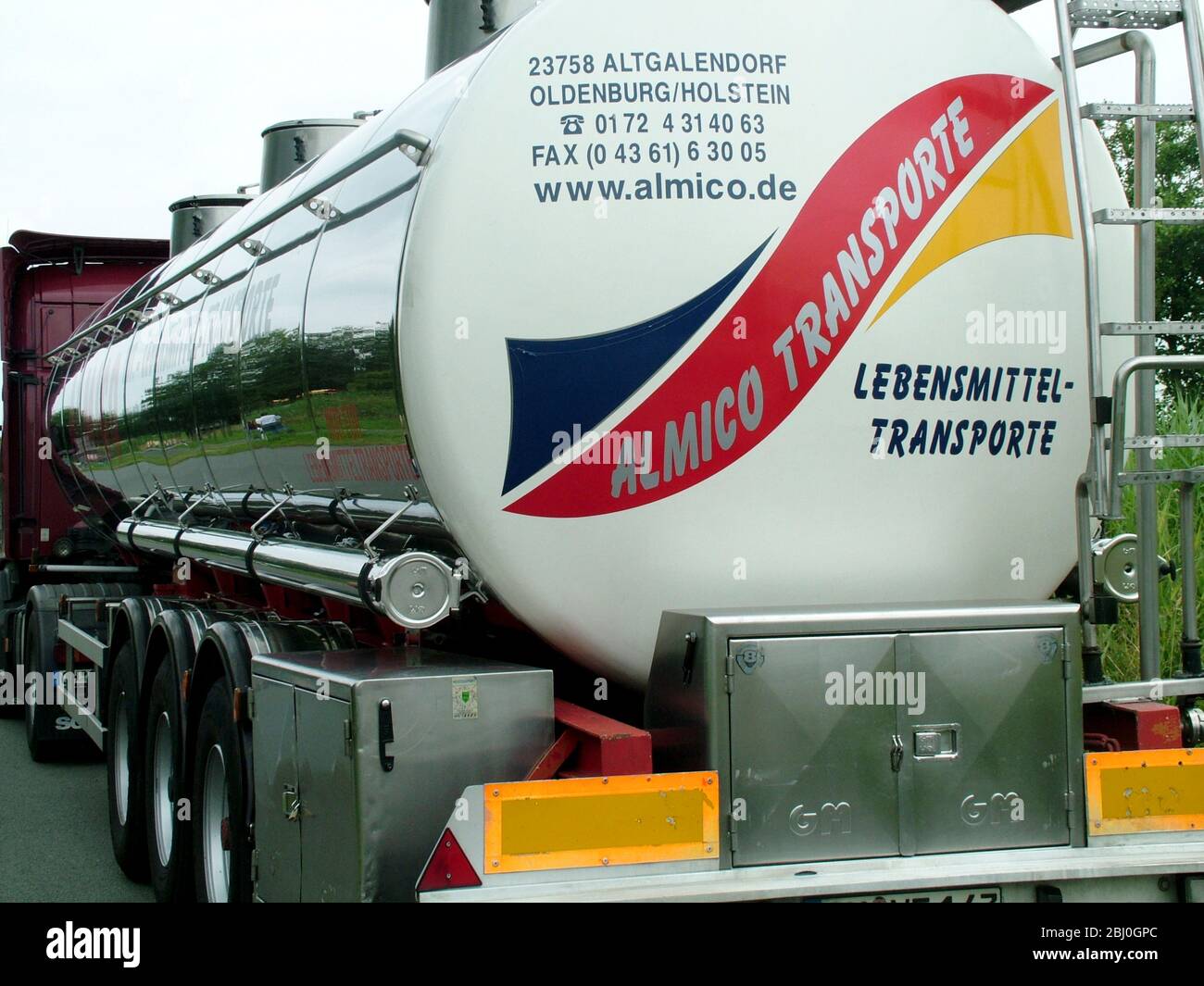 Huge stainless steel road tanker, transporting food stuff in Germany - Stock Photo