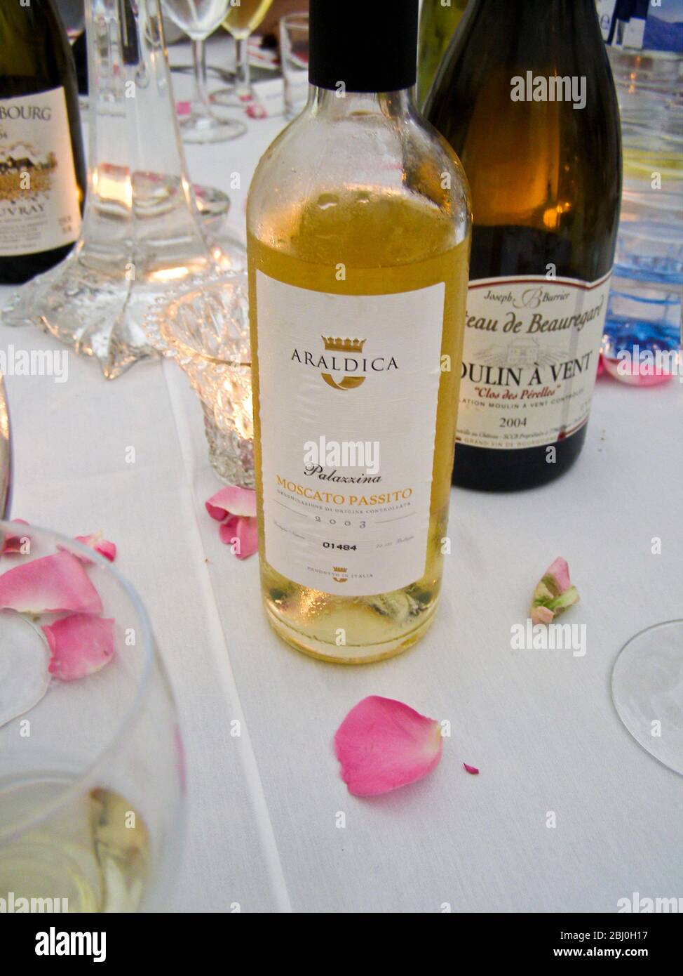 Wines on wedding reception dinner table - Moulin a Vent Clos des PŽrelles and Palazzina, Moscato Passito - Stock Photo