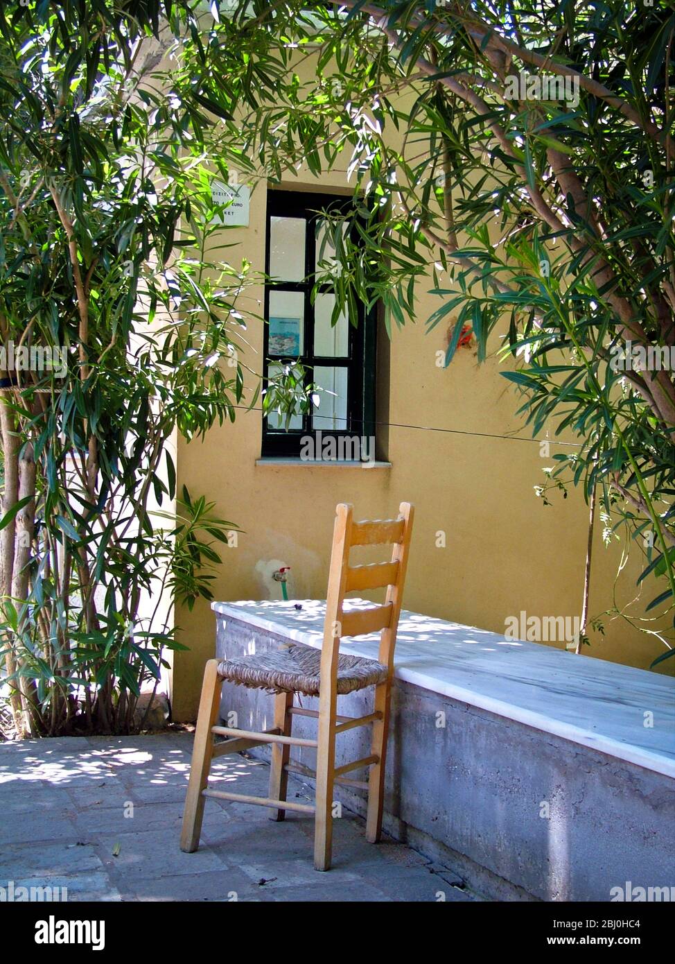 Chair and marble counter outside entrance to Asclepieion, Kos Greece - Stock Photo