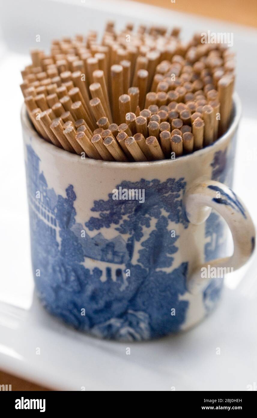 SIngle ended toothpicks in pretty old 'Adams' 'Landscape' cup. Putting antique and junshop finds to practical use. - Stock Photo