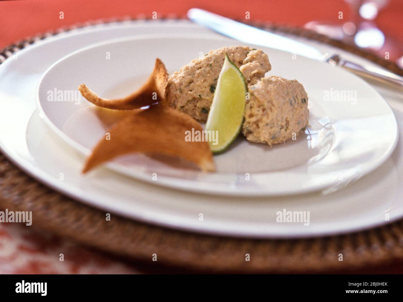 Fish pate with melba toast and lime wedge - Stock Photo