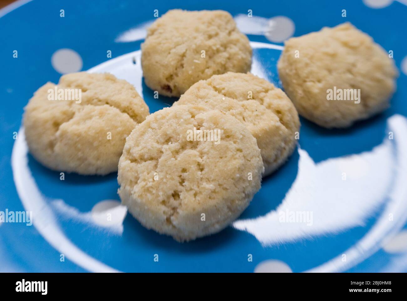 Melting Moments cookies on spotty blue and white plate - Stock Photo