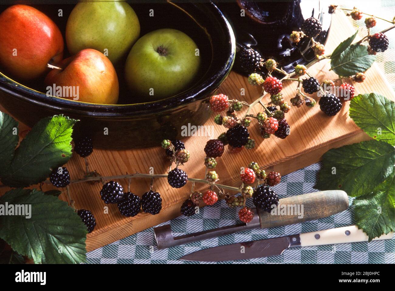 Ingredients for blackberry and apple pie in kitchen setting - Stock Photo