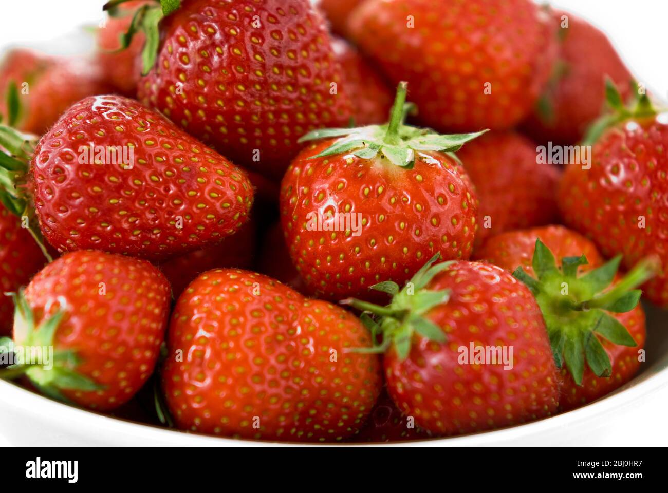 Close up of bowl of ripe red strawberries. - Stock Photo