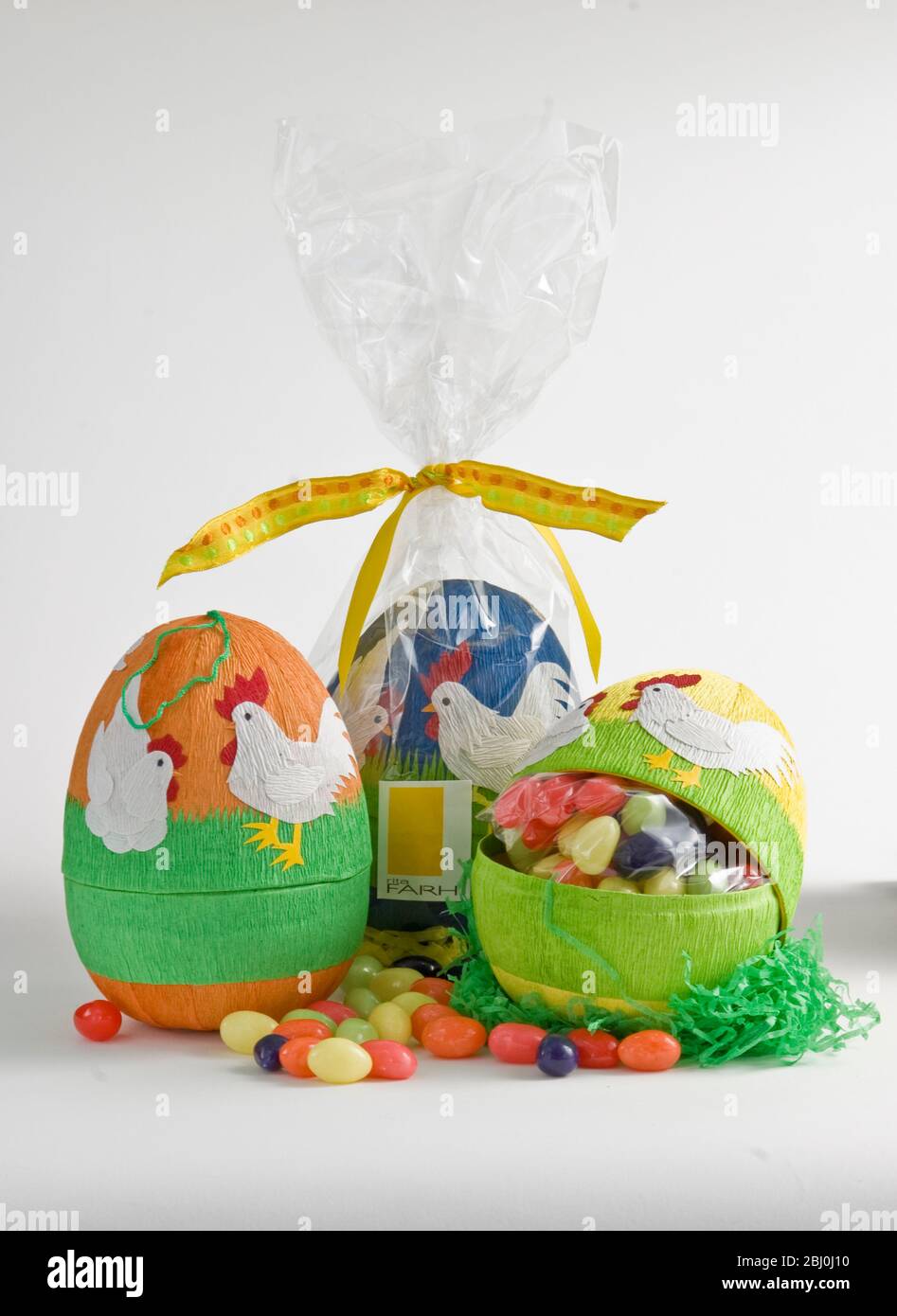 Egg shaped decorated paper box with sugar coated chocolate eggs - Stock Photo
