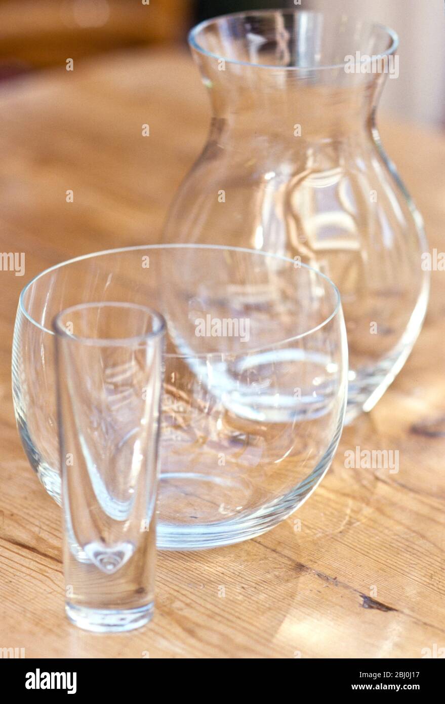 Collection of empty glass vases on wooden table - Stock Photo