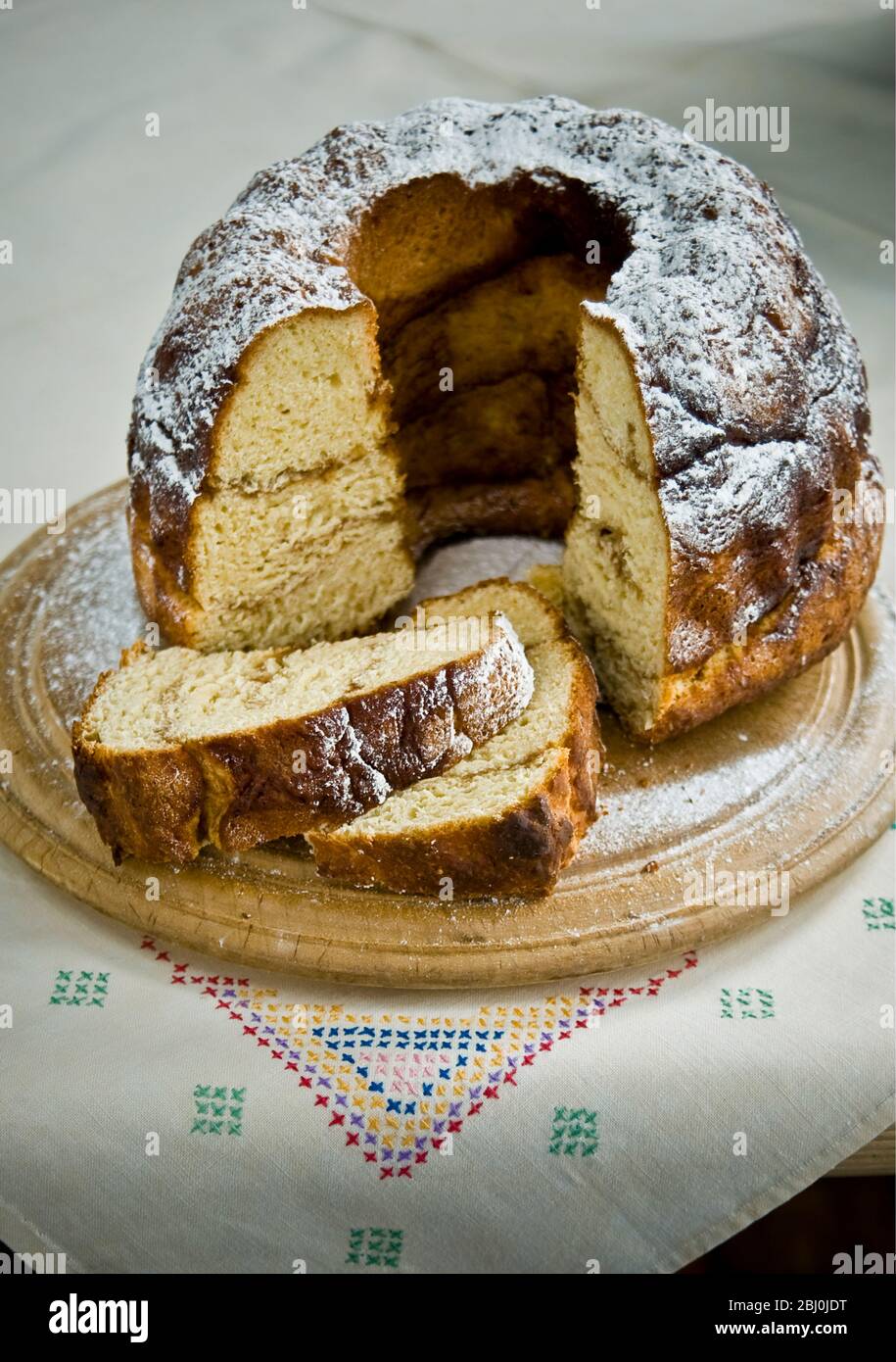 Cinnamon yeast cake baked in tall ring shaped cake tin Stock Photo