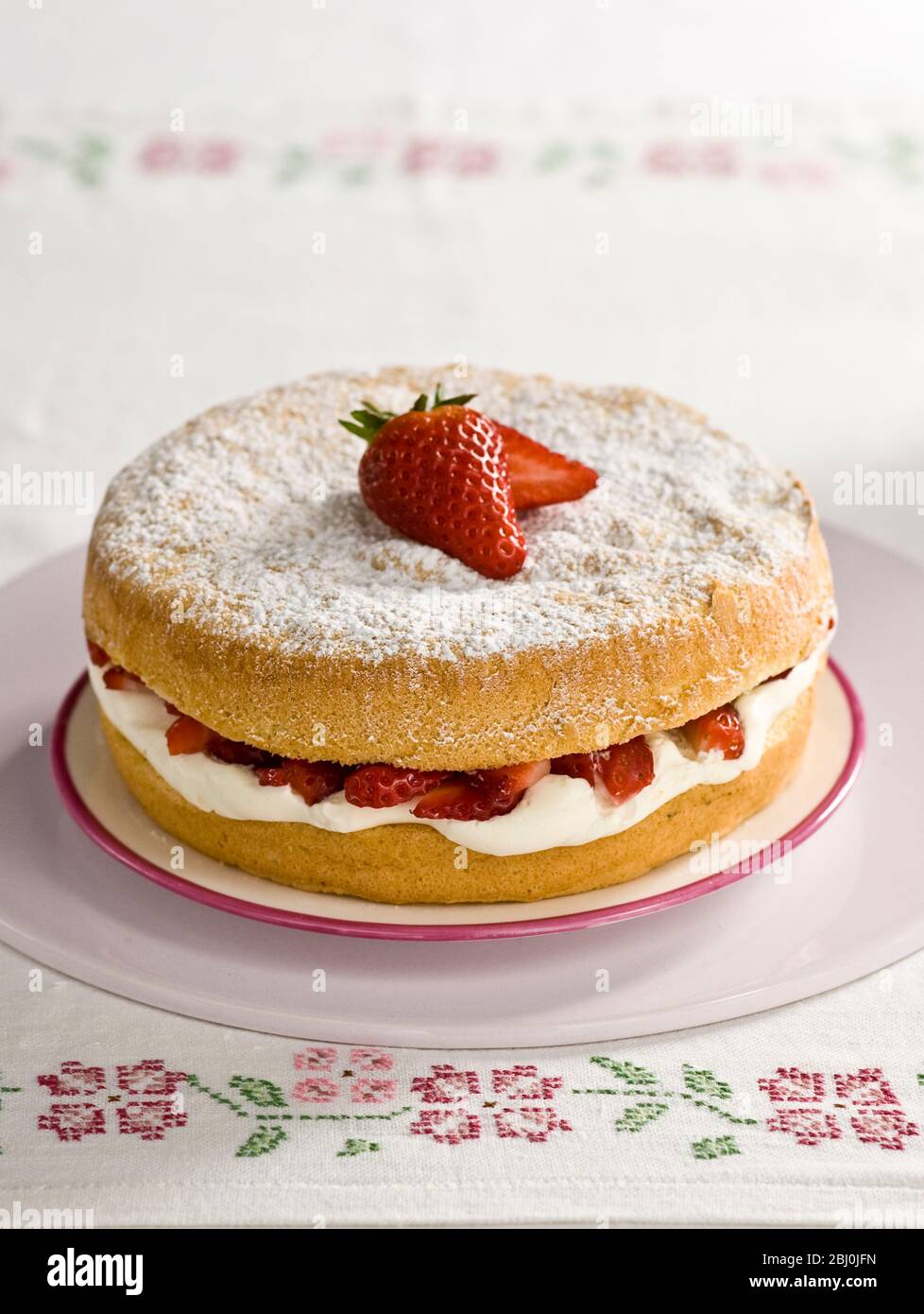 American sponge cake with whipped cream and strawberries Stock Photo
