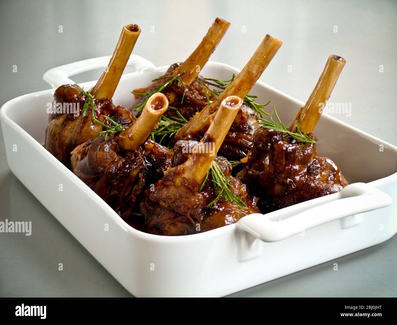 Slow cooked braised lamb shanks with rosemary Stock Photo - Alamy