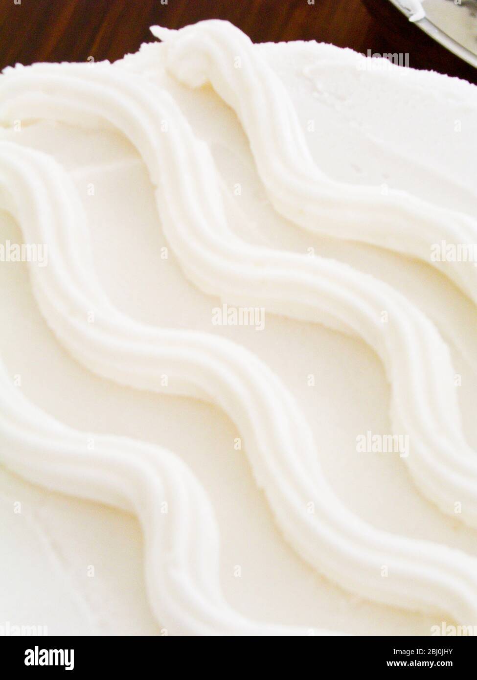 Detail of simple wavy design on iced cake - Stock Photo