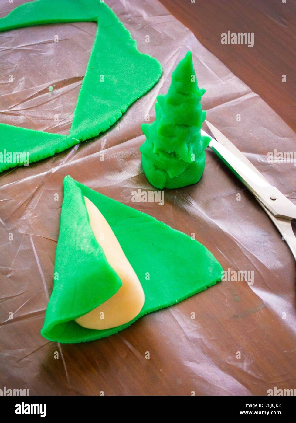 Making decorative marzipan christmas tree for cake decoration - Stock Photo