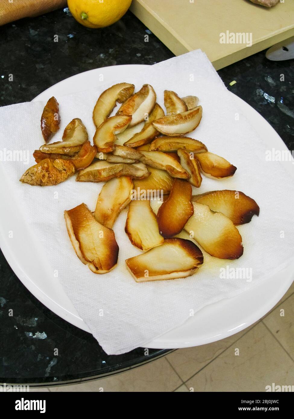 Slices of ceps quickly fried in hot olive oil. - Stock Photo