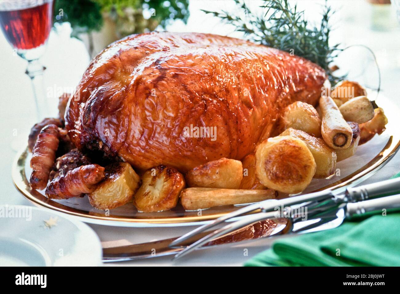 Turkey crown roast (white meat of the turkey only, without legs or wings) with roast vegetables and rosemary - Stock Photo